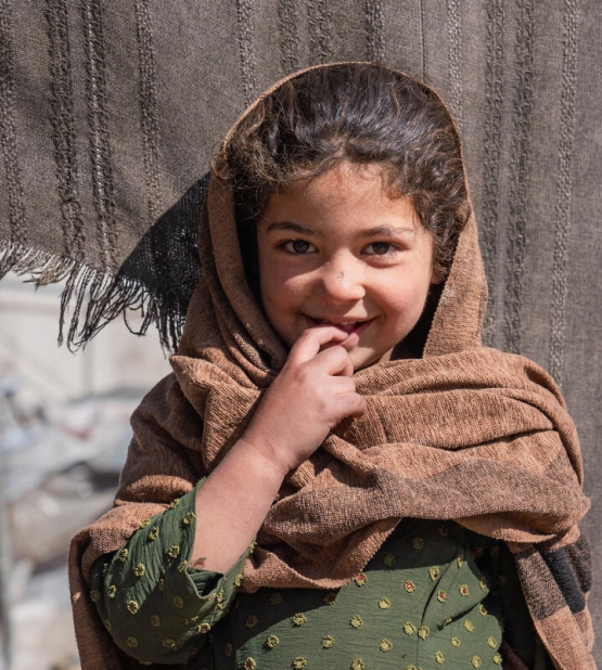 Nilofar, 6, lives with her family in a tent in an informal settlement, where she faces the challenges of displacement and harsh living conditions. Despite the difficulties, Nilofar finds comfort in the small moments with her family. Like many children in the settlement, she is impacted by the lack of basic resources, and her family struggles to provide for her needs. They rely on collecting plastic and trash to burn for warmth, as the cold winter intensifies the hardships they face. Nilofar shows resilience