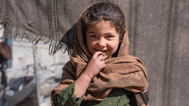 Nilofar, 6, lives with her family in a tent in an informal settlement, where she faces the challenges of displacement and harsh living conditions. Despite the difficulties, Nilofar finds comfort in the small moments with her family. Like many children in the settlement, she is impacted by the lack of basic resources, and her family struggles to provide for her needs. They rely on collecting plastic and trash to burn for warmth, as the cold winter intensifies the hardships they face. Nilofar shows resilience